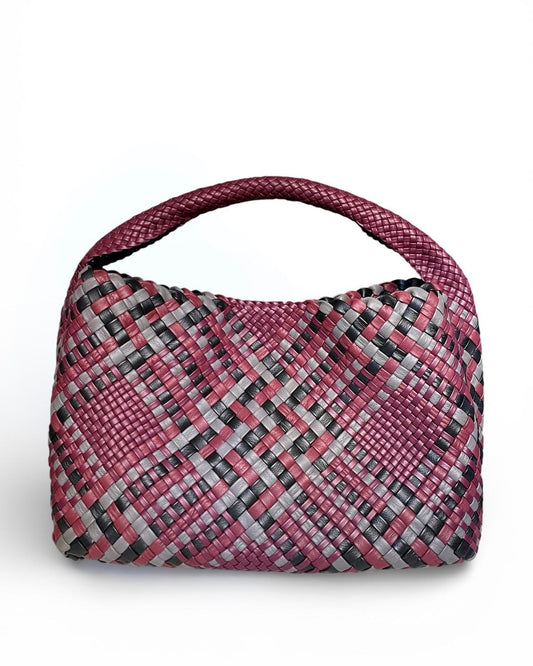 Woven handbag with pink and black plaid pattern on a white background