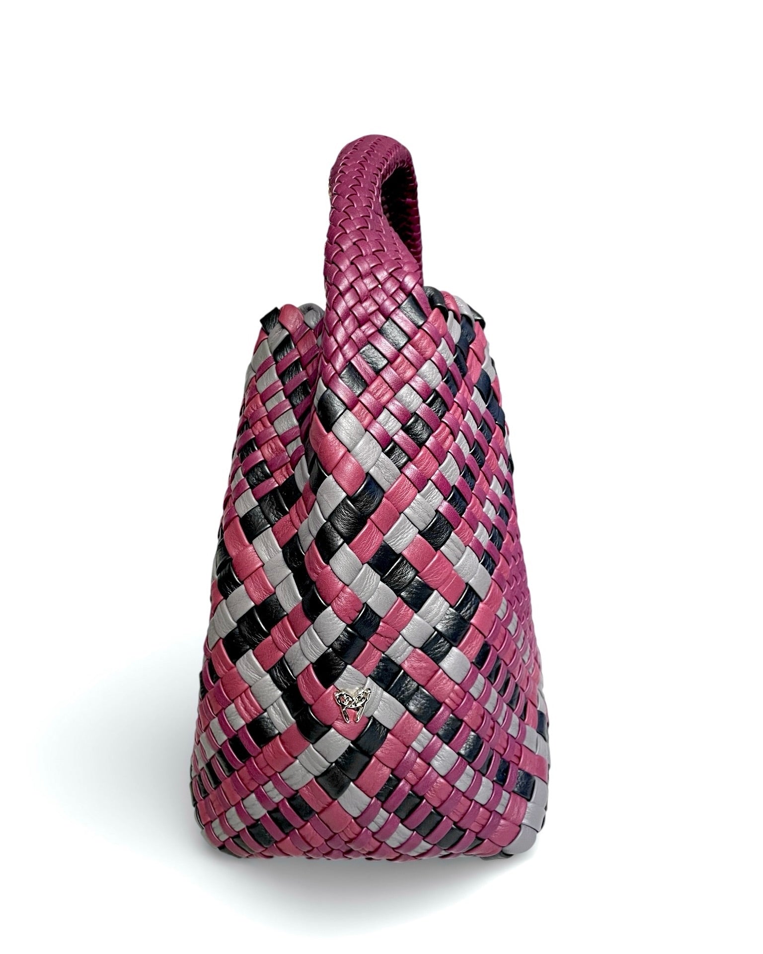 Woven handbag with pink, black, and gray pattern on a white background
