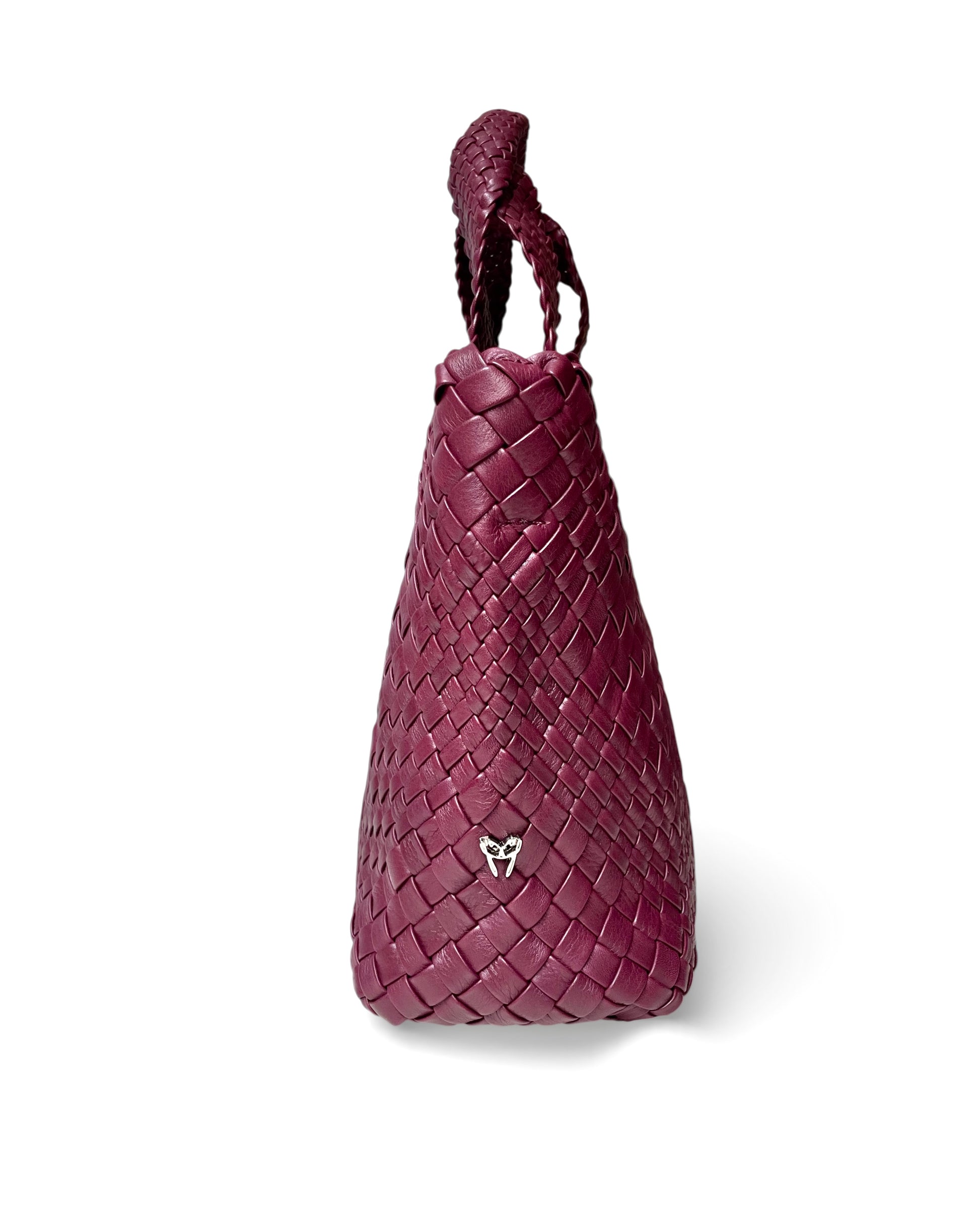Woven purple handbag on a white background